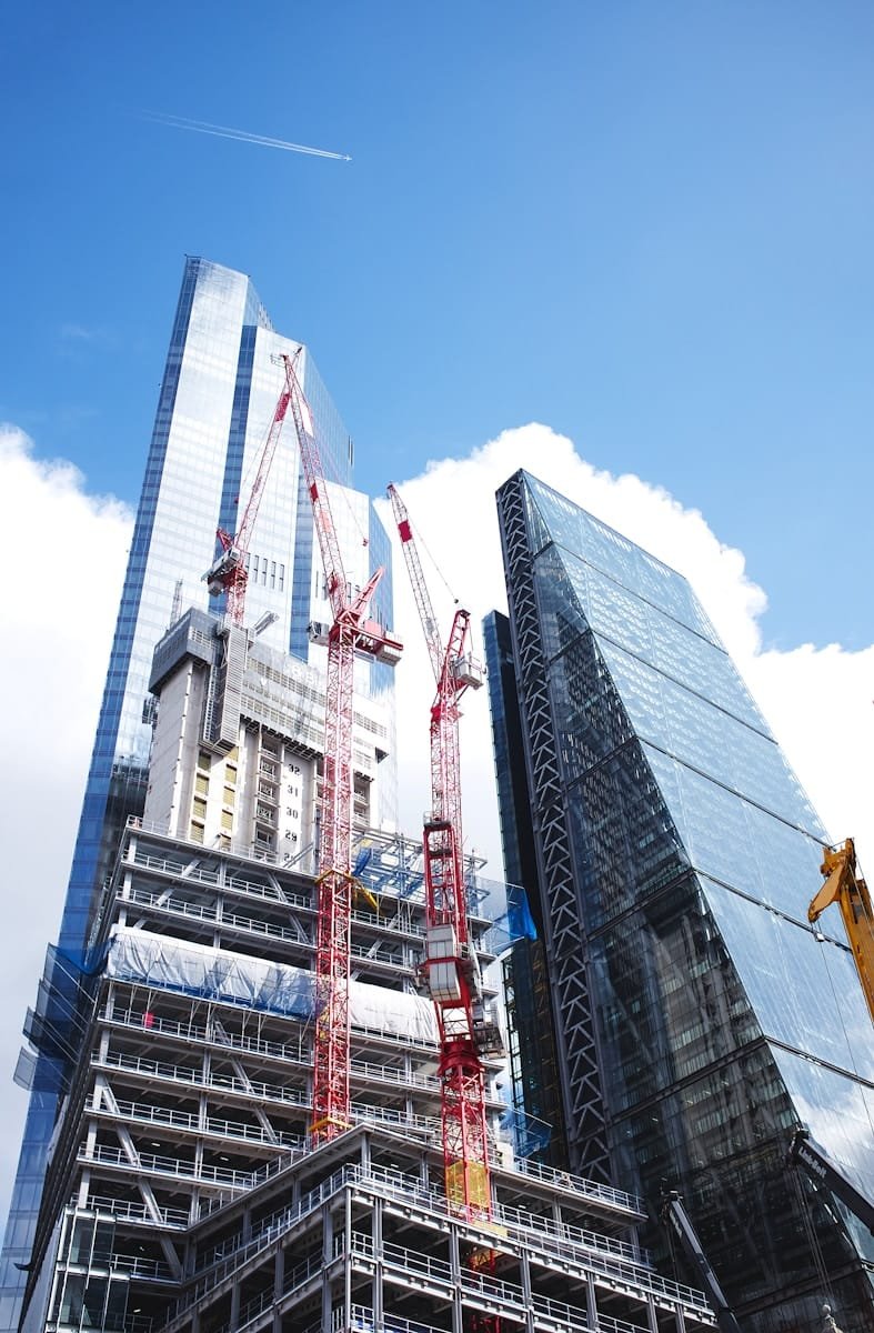 Photo by Max Whitehead gray concrete building under blue sky during daytime