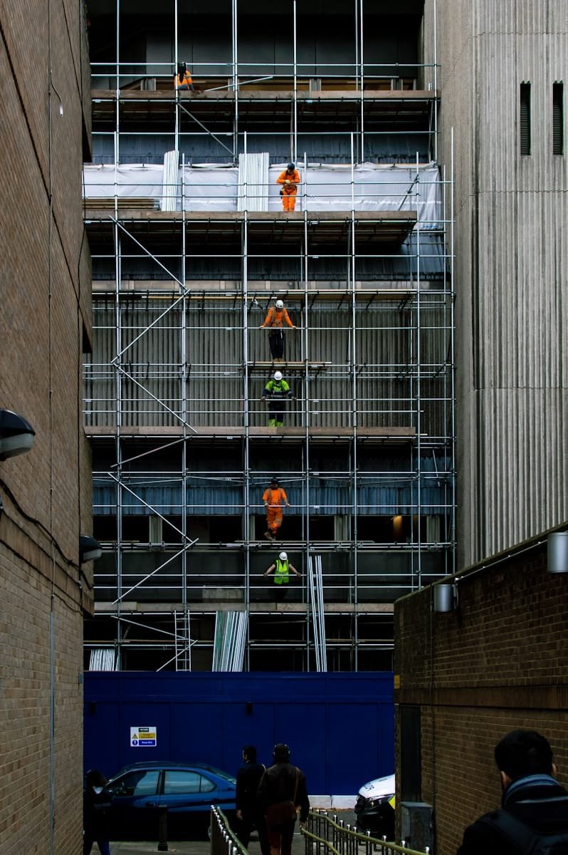 Photo by Chris Gray Construction workers on scaffolding at a building site, supporting construction engineer recruitment