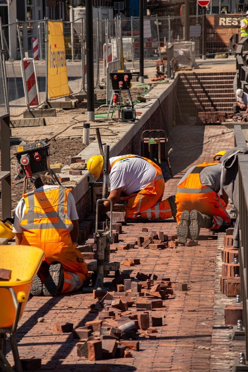 Bricklayer recruitment a group of construction workers working on a brick walkway